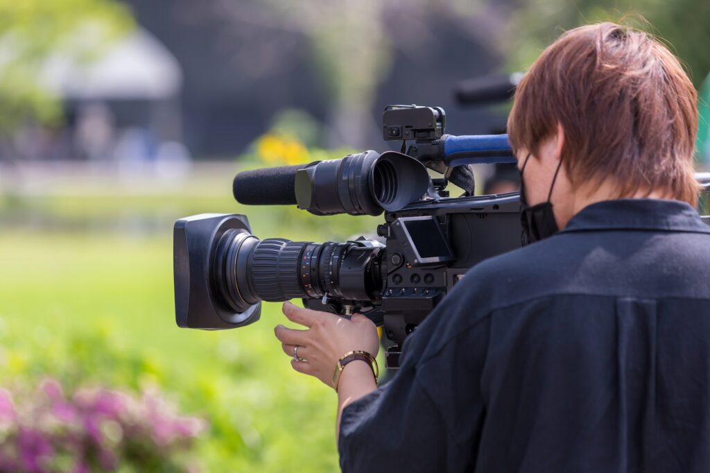 Video camera operator working with his equipment. video cinema production.